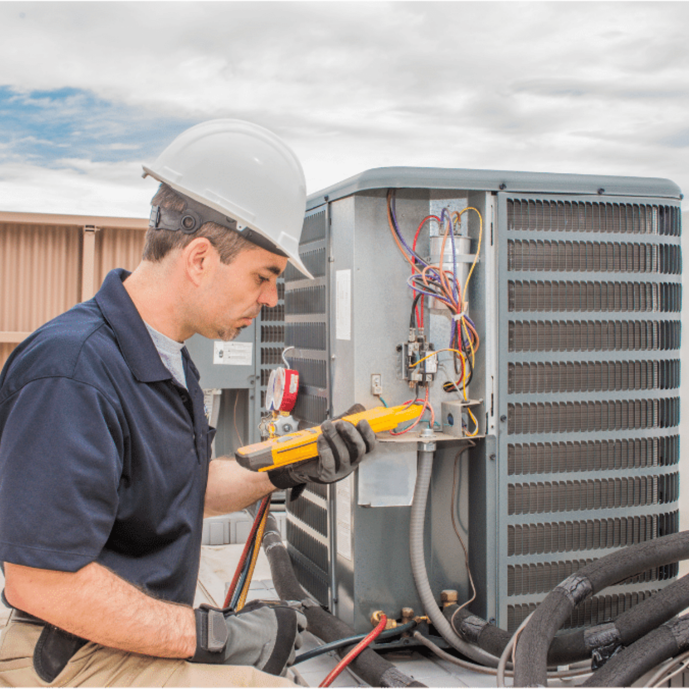 Tecumseh Heating & Cooling HVAC technician servicing a system