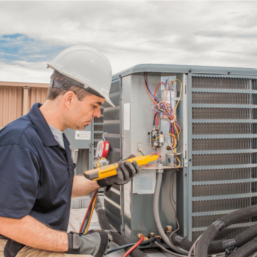 Tecumseh Heating & Cooling HVAC technician servicing a system